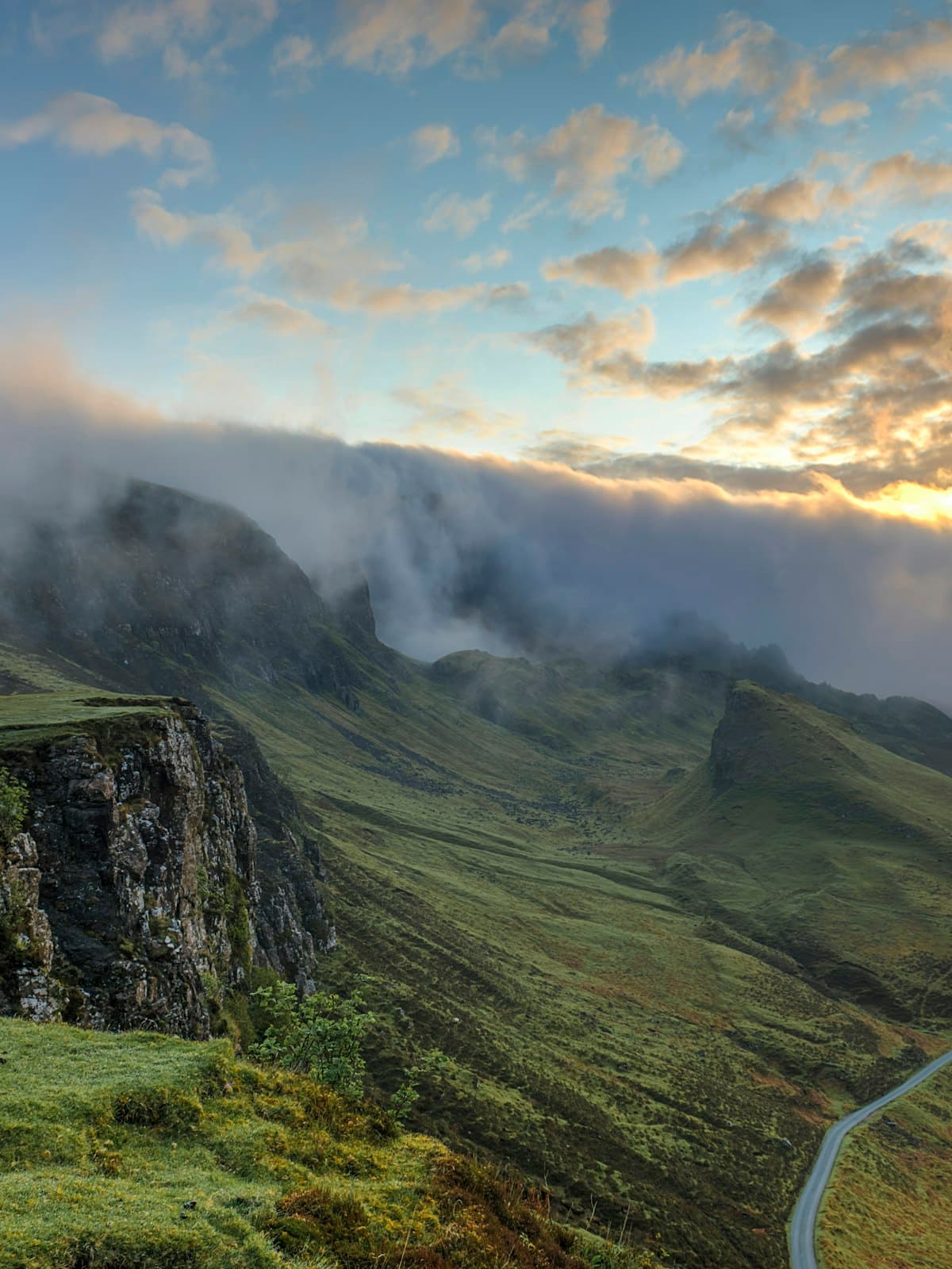 Placeholder: green cliffs under drifting cloud.
