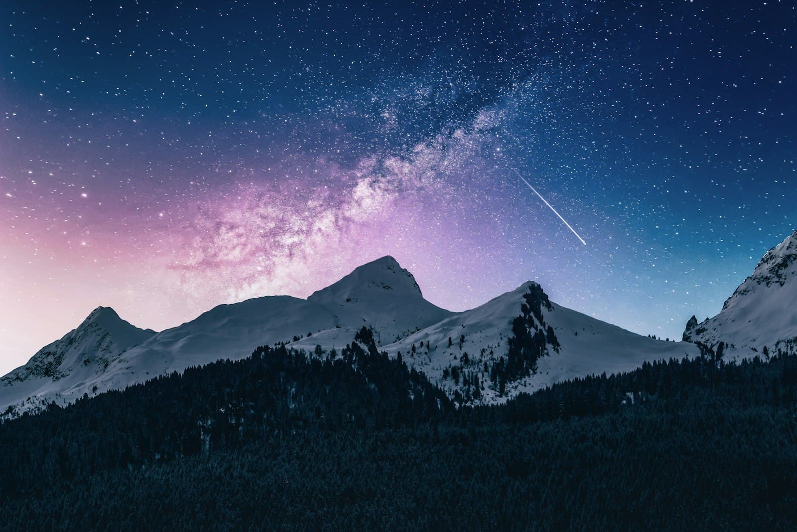 Placeholder: the Milky Way over a snowy mountain.