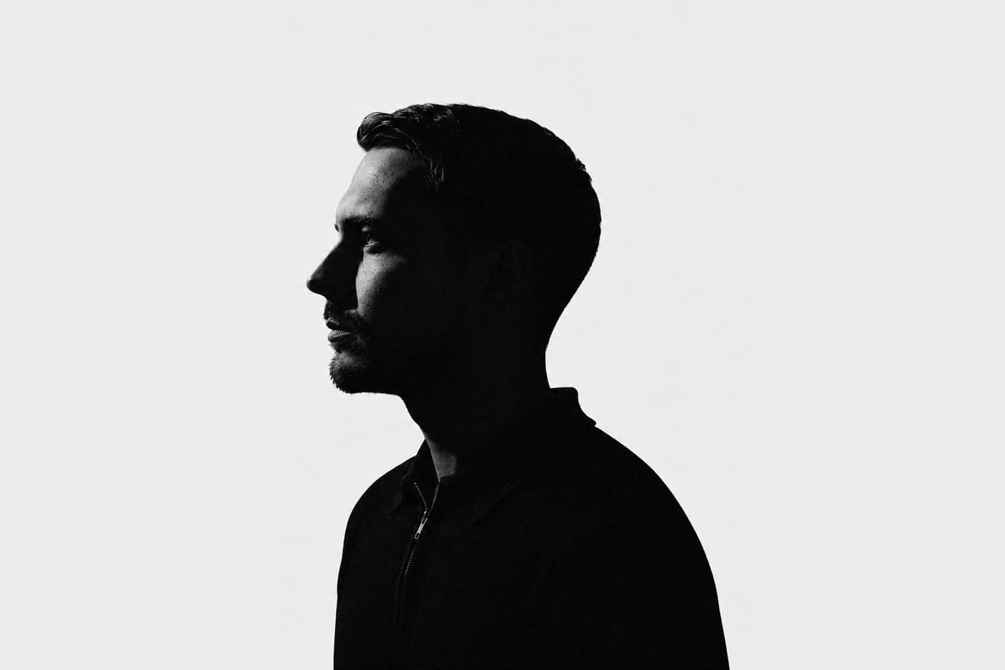 Răzvan Țugui in profile, a silhouette against a white background.